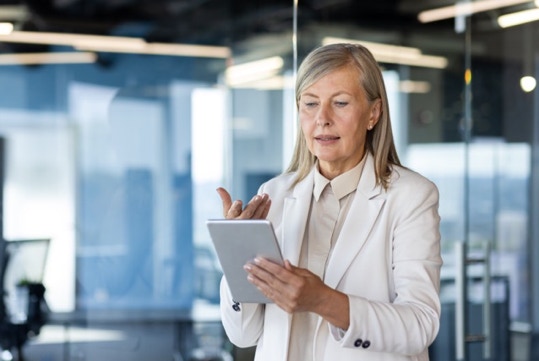 Older woman reading from an electronic tablet